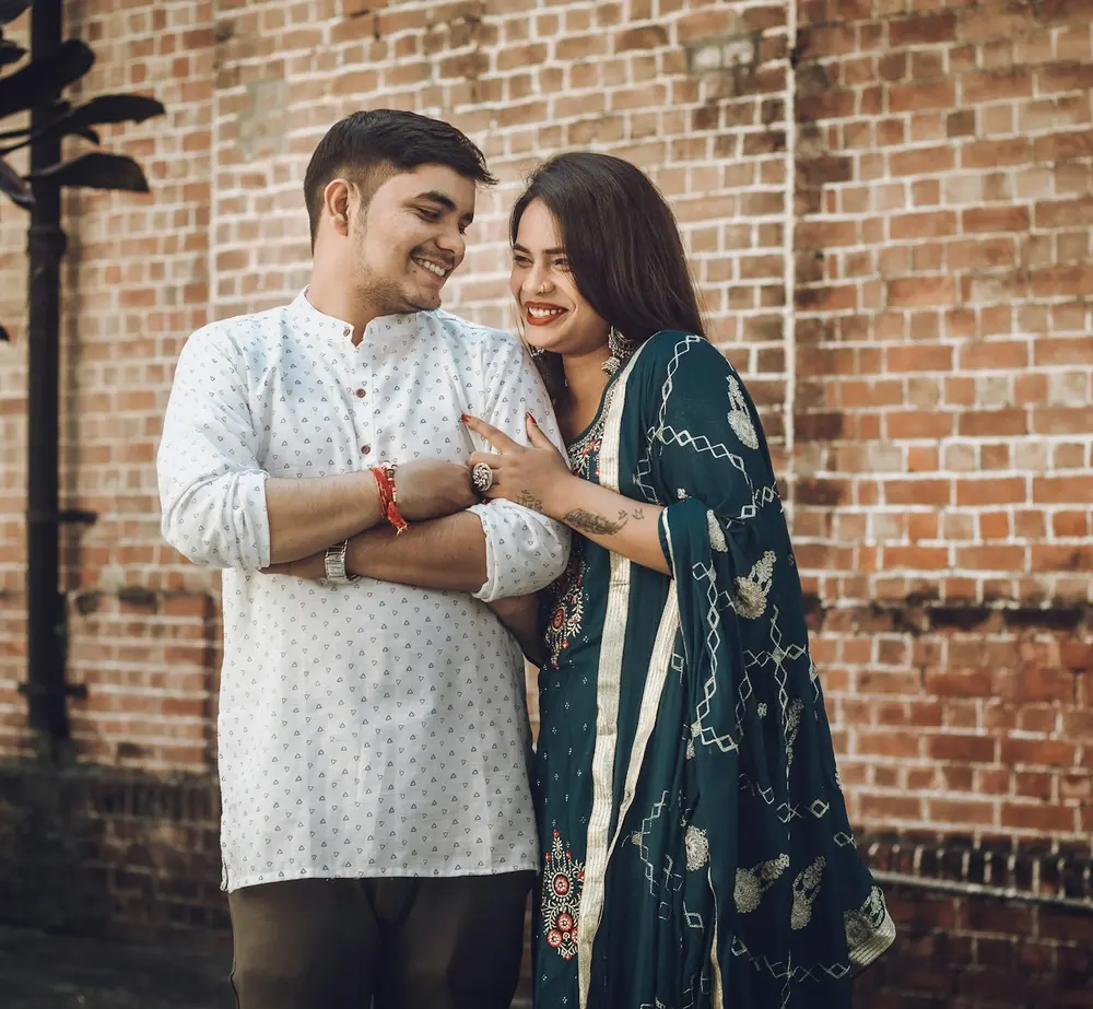 A smiling couple in kurta and salwar suit